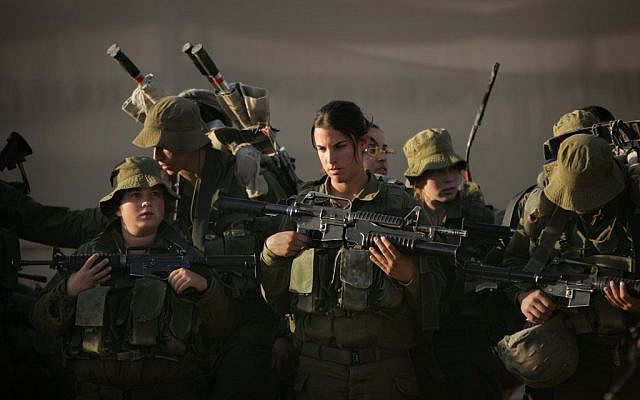 This file photo shows female soldiers preparing for a march near Ein Yahav in southern Israel in 2006 (photo credit: AP Photo/Oded Balilty, File)