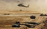 An Israeli helicopter flies above armored vehicles during an army exercise at the Shizafon Army Base in southern Israel. (photo credit: Tara Todras-Whitehill/AP)