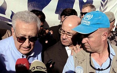 Lakhdar Brahimi (left) during his visit to the Zaatari refugee camp in Jordan, September 18 (photo credit: AP/Raad Adayleh)