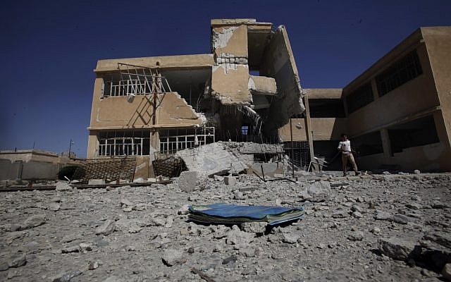 A book is left on the ground at the yard of a school destroyed in government airstrike in Tel Rifaat, on the outskirts of Aleppo on Sunday. (photo credit: AP/Muhammed Muheisen) A book is left on the ground at the yard of a school destroyed in government airstrike in Tel Rifaat, on the outskirts of Aleppo on Sunday. (photo credit: AP/Muhammed Muheisen)