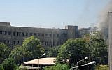 Smoke rising from Syria's army command headquarters in Damascus, Wednesday, after twin blasts rocked the area (photo credit: AP Photo/SANA)