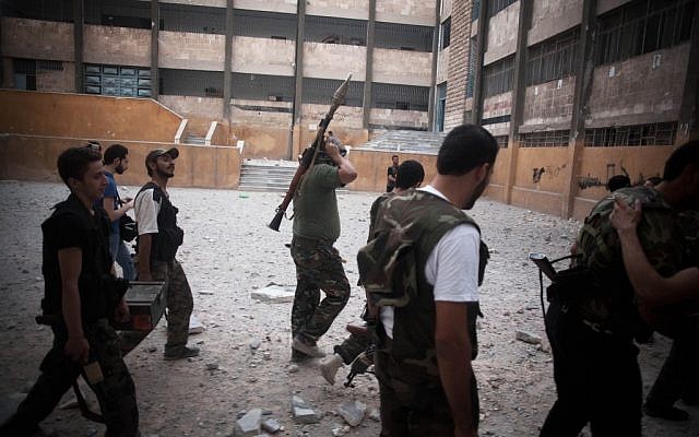 FSA soldiers go to the front line in Izaa district in Aleppo, Syria, Sunday, Sept. 9, 2012 (photo credit: Manu Brabo/ AP)