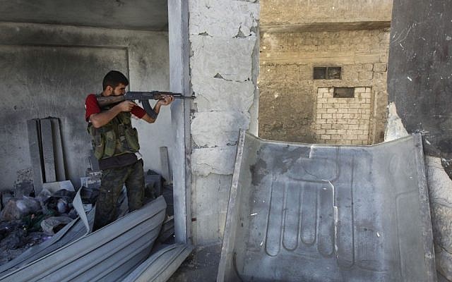 A Free Syrian Army Soldier takes his position in Aleppo, September 24 (photo credit: AP/Hussein Malla) A Free Syrian Army Soldier takes his position in Aleppo, September 24 (photo credit: AP/Hussein Malla)
