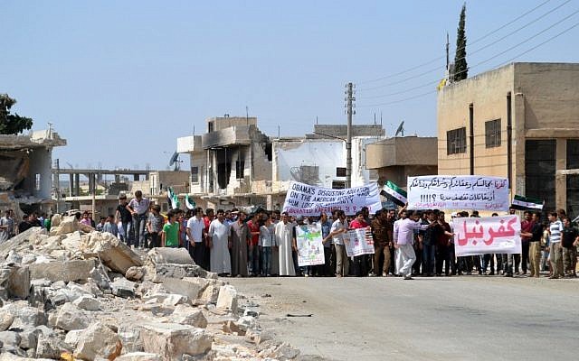 This citizen journalism image shows an anti-Assad protestors in Idlib province, northern Syria. Despite weeks of intense bombardments by the Syrian military, the civil war shows no sign of ending soon. (photo credit: AP Photo/Shaam News Network, SNN) This citizen journalism image shows an anti-Assad protestors in Idlib province, northern Syria. Despite weeks of intense bombardments by the Syrian military, the civil war shows no sign of ending soon. (photo credit: AP Photo/Shaam News Network, SNN)