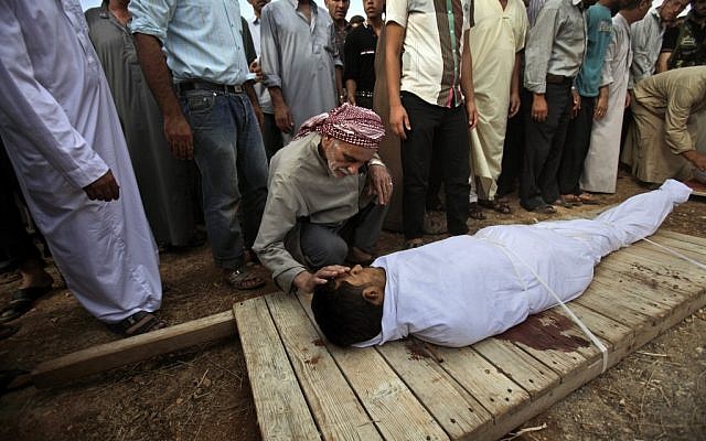 A Syrian man touches the body of his son during a funeral for four men who were killed in a government airstrike on the outskirts of Aleppo, Syria, Tuesday, Sept. 11, 2012. (photo credit: AP/Muhammed Muheisen) A Syrian man touches the body of his son during a funeral for four men who were killed in a government airstrike on the outskirts of Aleppo, Syria, Tuesday, Sept. 11, 2012. (photo credit: AP/Muhammed Muheisen)