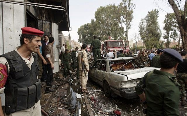 Yemeni soldiers at the site of a car bomb attack in Sanaa', September 11 (photo credit: AP/Hani Muhammad)