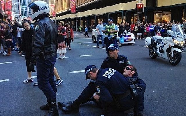 A police officer is injured during a violent demonstration Saturday in central Sydney, Australia (photo credit: Twitter)