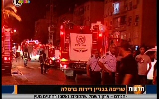 Fire and rescue crews outside a Ramle building where a woman was killed  and several others were injured on Sunday (image capture: channel 10 News)