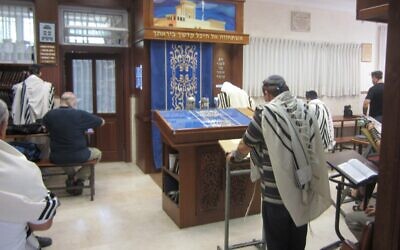 A man prays in a synagogue (Illustrative photo credit: Ben Sales/JTA)