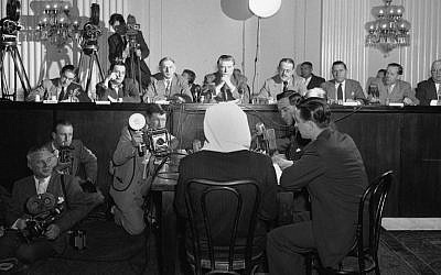 In this Feb. 6, 1952 file photo, a masked former Polish soldier testifies on the 1940 Katyn Forest massacre to a house committee in Washington. Documents released Monday, Sept. 10, 2012 lend weight to the belief that suppression within the highest levels of the US government helped cover up Soviet guilt.(photo credit: AP Photo/Bill Allen)
