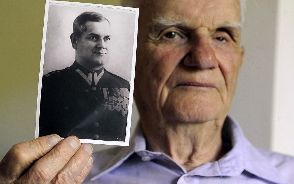 Franciszek Herzog holds a photograph of his father, also named Franciszek Herzog, in Hebron, Conn. Herzog's father and uncle both died in the Katyn Forest massacres. (photo credit: AP Photo/Jessica Hill) Franciszek Herzog holds a photograph of his father, also named Franciszek Herzog, in Hebron, Conn. Herzog's father and uncle both died in the Katyn Forest massacres. (photo credit: AP Photo/Jessica Hill)