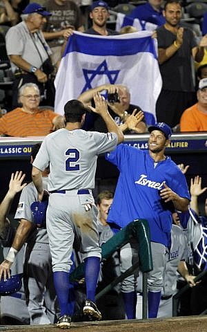 Israel's Josh Satin (2) is congratulated after scoring on a double by Charlie Cutler against South Africa in the eighth inning of a World Baseball Classic qualifier baseball game in Jupiter, Florida, on Wednesday, September 19, 2012 (photo credit: AP Photo/Alan Diaz)