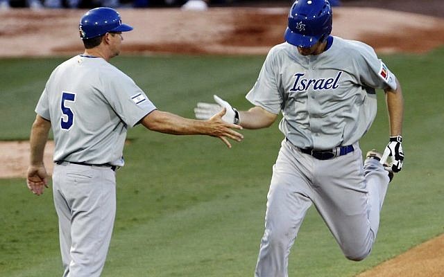 Israel's Nate Freiman, right, is congratulated by third base coach Mark Loretta after hitting a home run against South Africa in the first inning of a World Baseball Classic qualifier baseball game in Jupiter, Florida, on Wednesday. (photo credit: AP Photo/Alan Diaz) Israel's Nate Freiman, right, is congratulated by third base coach Mark Loretta after hitting a home run against South Africa in the first inning of a World Baseball Classic qualifier baseball game in Jupiter, Florida, on Wednesday. (photo credit: AP Photo/Alan Diaz)