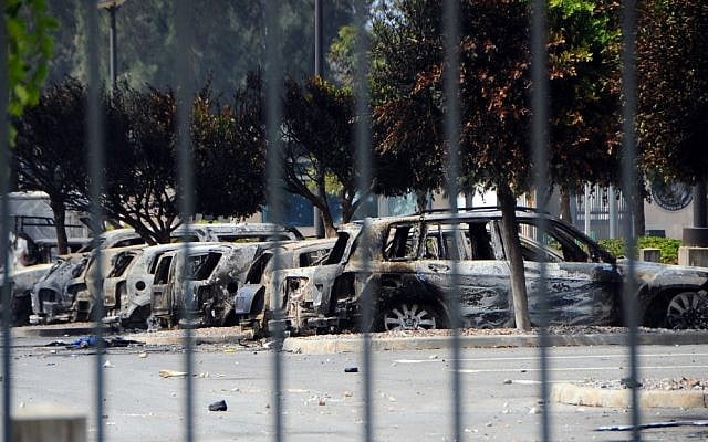 View of several dozen burned cars in the parking lot of the U.S. Embassy, a day after several thousand demonstrators angry over a film that insults the Prophet Muhammad stormed the compound, Tunis, Tunisia, on Saturday. (photo credit: AP/Hassene Dridi)
