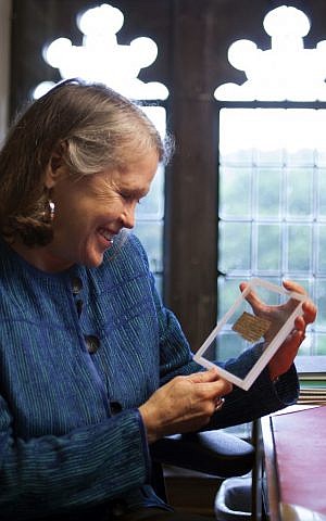 In this Sept. 5, 2012 photo released by Harvard University, divinity professor Karen L. King holds a fourth century fragment of papyrus that she says is the only existing ancient text that quotes Jesus explicitly referring to having a wife (photo credit: AP Photo/Harvard University, Rose Lincoln)