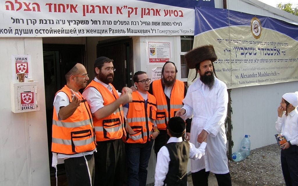 Four paramedics welcome a patient at the entrance of the Uman Emergency Clinic near the start of Rosh Hashanah. (Cnaan Liphshitz/JTA) Four paramedics welcome a patient at the entrance of the Uman Emergency Clinic near the start of Rosh Hashanah. (Cnaan Liphshitz/JTA)
