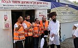 Four paramedics welcome a patient at the entrance of the Uman Emergency Clinic near the start of Rosh Hashanah. (Cnaan Liphshitz/JTA)