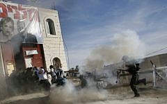 Israeli security forces enter and forcibly evict some 250 settlers and their supporters from a disputed building in the West Bank city of Hebron in December 2008, about three weeks after the High Court of Justice ordered its immediate evacuation (photo credit: Miriam Alster/Flash90)
