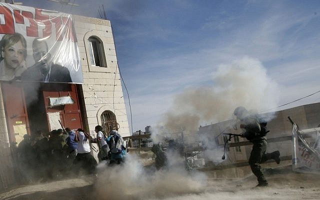 Israeli security forces enter and forcibly evict some 250 settlers and their supporters from a disputed building in the West Bank city of Hebron in December 2008, about three weeks after the High Court of Justice ordered its immediate evacuation (photo credit: Miriam Alster/Flash90)