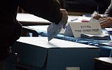 Illustrative: A voter casts a vote in a ballot box during Knesset elections on February 10, 2009. (Yossi Zamir/Flash90)