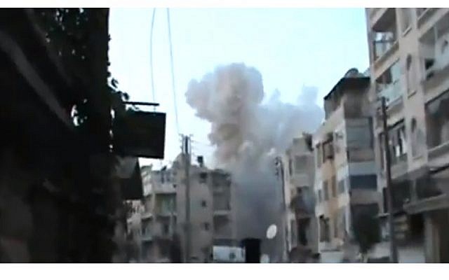 Syrian air force bombs an Aleppo neighborhood on Thursday, August 30. (photo credit: Image capture from YouTube video uploaded by SpaceIraneesKiller)