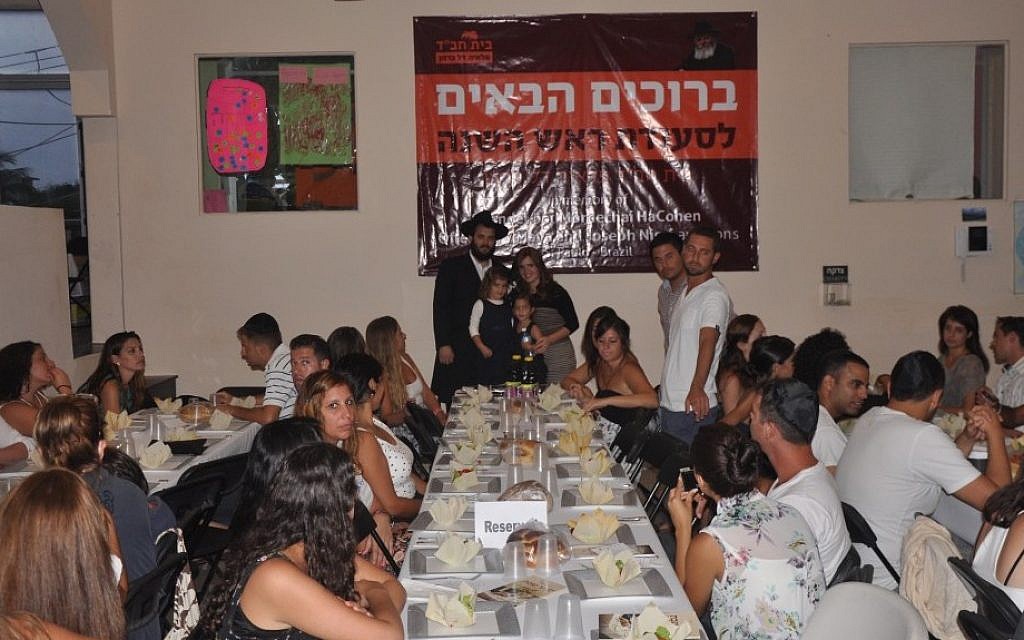 Guests at the Chabad Rosh Hashanah meal in Playa, Mexico, with Rabbi Mendel and wife Chaya at back (photo credit: Chabad, Playa del Carmen)