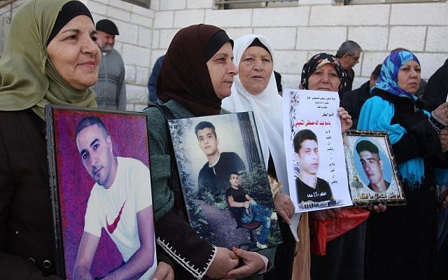 Palestinians holding pictures of their jailed sons in 2011. (photo credit: Issam Rimawi/Flash90)