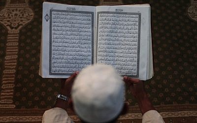 A Palestinian Muslim reads the Holy Quran at the Al-Omari mosque in the Gaza Strip. (photo credit: Wissam Nassar/Flash90)