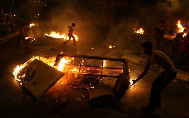 Palestinian youth burn tires and block a main road in the West bank city of Ramallah as they protest against high costs of living on Saturday, Sept. 08 (photo credit: Issam Rimawi/Flash90) Palestinian youth burn tires and block a main road in the West bank city of Ramallah as they protest against high costs of living on Saturday, Sept. 08 (photo credit: Issam Rimawi/Flash90)