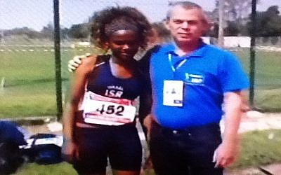 Tigist Bito, 15, with her coach. (photo credit: Image capture from Channel 2)