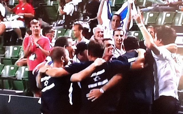 Amir Weintraub (right in white) celebrates victory with the rest of the Israeli Davis Cup team in Tokyo on Friday (photo credit: Sports5 screenshot) Amir Weintraub (right in white) celebrates victory with the rest of the Israeli Davis Cup team in Tokyo on Friday (photo credit: Sports5 screenshot)