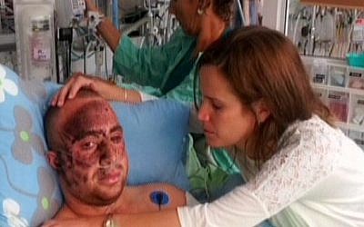Capt. Ziv Shilon, who lost an arm in a Gaza border bombing, recovers in hospital (photo credit: image capture from Channel 10)
