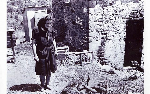 A woman examines the wreckage left behind by soldiers of the Hermann Goering division following a reprisal massacre in the Italian town of San Pancrazio in July 1944 (photo credit: National Archives of Canada) A woman examines the wreckage left behind by soldiers of the Hermann Goering division following a reprisal massacre in the Italian town of San Pancrazio in July 1944 (photo credit: National Archives of Canada)