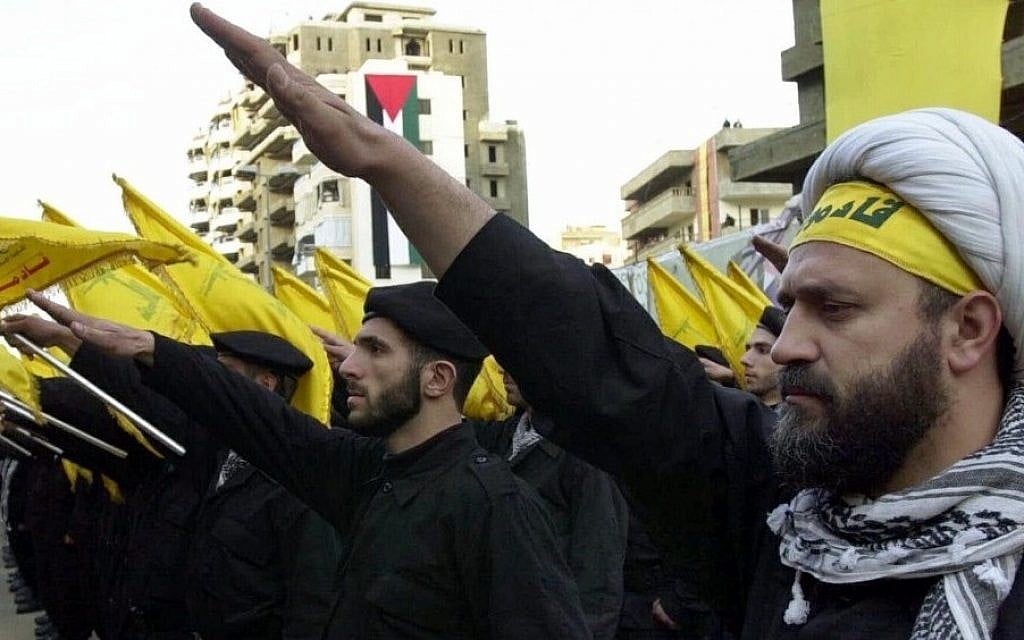Hezbollah fighters take an oath during a parade to continue the path of resistance against Israel. (photo credit: AP/Hussein Malla) Hezbollah fighters take an oath during a parade to continue the path of resistance against Israel. (photo credit: AP/Hussein Malla)