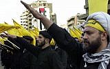 Hezbollah fighters take an oath during a parade to continue the path of resistance against Israel. (photo credit: AP/Hussein Malla)