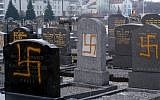 Illustrative photo of desecrated graves in the main Jewish cemetery of Strasbourg, France, in 2010 (photo credit: AP/Christian Lutz)