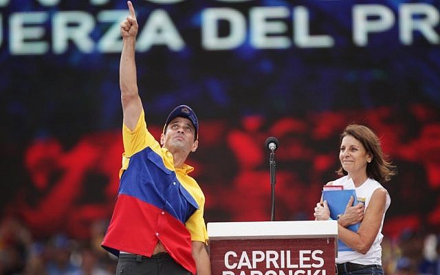 Opposition presidential candidate Henrique Capriles Radonski greets supporters with his mother, Monica Radonski, during a campaign rally in Caracas, Venezuela, on Sunday. Capriles is running against President Hugo Chavez in the country's Oct. 7 election. (photo credit: Rodrigo Abd/AP Photo) Opposition presidential candidate Henrique Capriles Radonski greets supporters with his mother, Monica Radonski, during a campaign rally in Caracas, Venezuela, on Sunday. Capriles is running against President Hugo Chavez in the country's Oct. 7 election. (photo credit: Rodrigo Abd/AP Photo)
