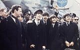 Brian Epstein (left) with The Beatles on tour in 1964. (AP Photo)