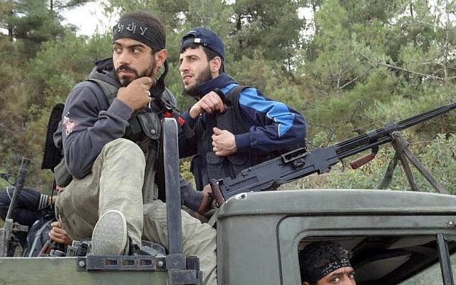 Free Syrian Army rebels capture an army truck at the village of Khirbet Al-Jouz, near Idlib, October 7 (photo credit: AP) Free Syrian Army rebels capture an army truck at the village of Khirbet Al-Jouz, near Idlib, October 7 (photo credit: AP)