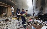 A Lebanese rescue man carries an injured boy at the scene of an explosion in the mostly Christian neighborhood of Achrafiyeh, Beirut, Lebanon, Friday Oct. 19, 2012 (photo credit: AP/Hussein Malla)