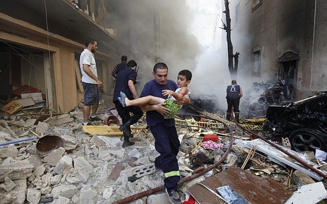 A Lebanese rescue man carries an injured boy at the scene of an explosion in the mostly Christian neighborhood of Achrafiyeh, Beirut, Lebanon, Friday Oct. 19, 2012 (photo credit: AP/Hussein Malla) A Lebanese rescue man carries an injured boy at the scene of an explosion in the mostly Christian neighborhood of Achrafiyeh, Beirut, Lebanon, Friday Oct. 19, 2012 (photo credit: AP/Hussein Malla)