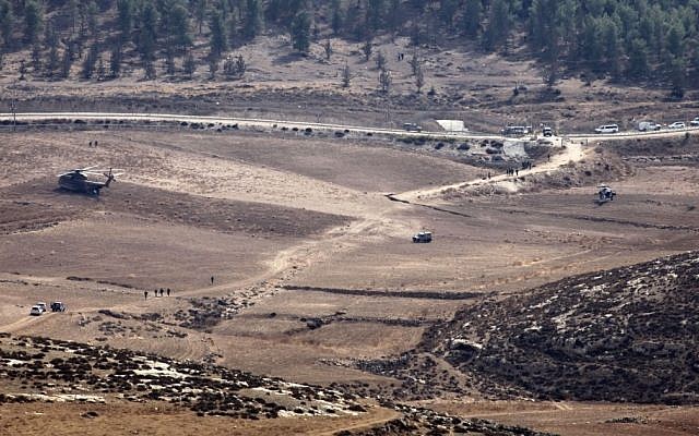 Israeli Army vehicles and helicopters are seen in an open area as they search for the remains of a drone in the Negev southern Israel on October 6, 2012. (photo credit: AP) Israeli Army vehicles and helicopters are seen in an open area as they search for the remains of a drone in the Negev southern Israel on October 6, 2012. (photo credit: AP)