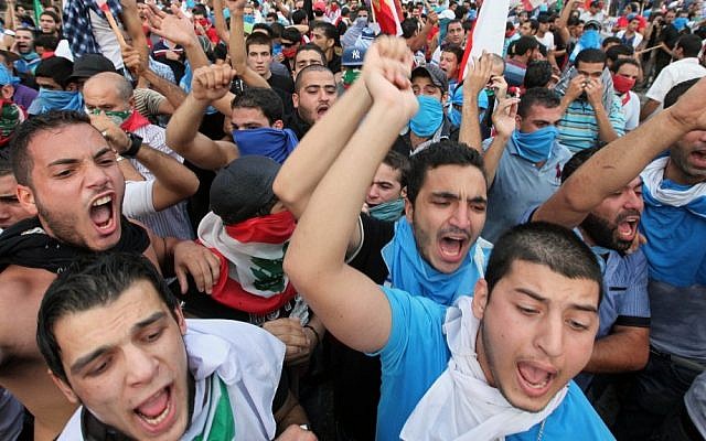 Lebanese protesters chant slogans against the Lebanese government after the funeral of Brig. Gen. Wissam al-Hassan on Sunday (photo credit: AP/Bilal Hussein) Lebanese protesters chant slogans against the Lebanese government after the funeral of Brig. Gen. Wissam al-Hassan on Sunday (photo credit: AP/Bilal Hussein)