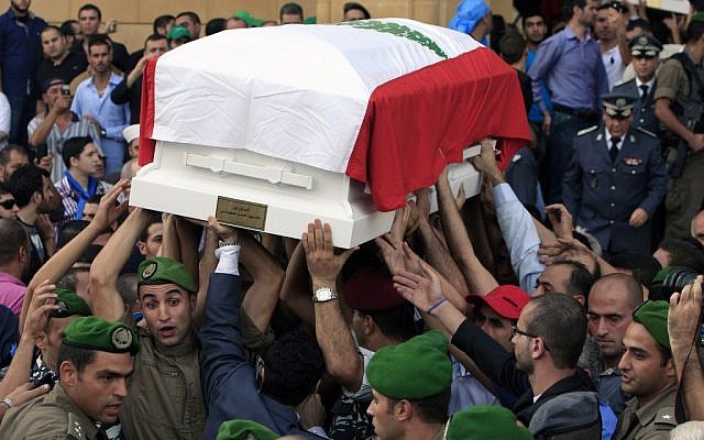Lebanese honor guards carry coffins wrapped with Lebanese flags of Brig. Gen. Wissam al-Hassan and his bodyguard, Ahmad Sahyouni, who were assassinated on Friday by a car bomb, during their funeral procession at Martyrs' Square in Beirut, October 21, 2012 (photo credit: AP/Bilal Hussein) Lebanese honor guards carry coffins wrapped with Lebanese flags of Brig. Gen. Wissam al-Hassan and his bodyguard, Ahmad Sahyouni, who were assassinated on Friday by a car bomb, during their funeral procession at Martyrs' Square in Beirut, October 21, 2012 (photo credit: AP/Bilal Hussein)