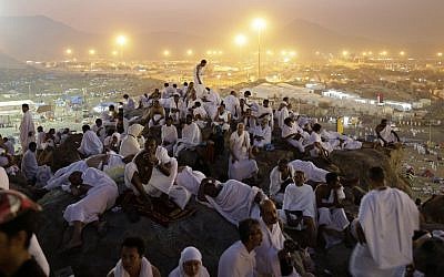 Muslim pilgrims pray on a rocky hill called the Mountain of Mercy, on the Plain of Arafat near the holy city of Mecca, Saudi Arabia, in the early hours of Thursday, Oct. 25, 2012. (photo credit: Hassan Ammar/AP)