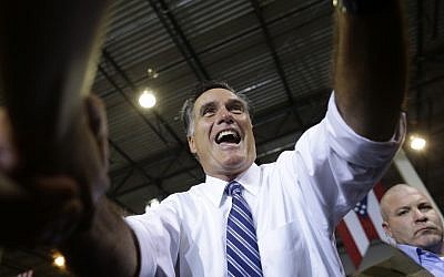 Republican presidential candidate Mitt Romney shakes hands with supporters while campaigning in Cincinnati, Ohio on Thursday (photo credit: AP/Charles Dharapak)