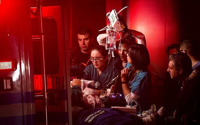 Medical workers assist a patient into an ambulance during an evacuation of New York University's Tisch Hospital, Monday, Oct. 29 (photo credit: AP/John Minchillo)