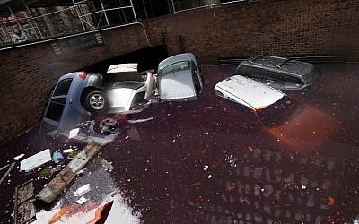 Cars are submerged at the entrance to a parking garage in New York's Financial District in the aftermath of superstorm Sandy, Tuesday, Oct. 30, 2012. (photo credit: Richard Drew/AP)