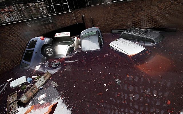 Cars are submerged at the entrance to a parking garage in New York's Financial District in the aftermath of superstorm Sandy, Tuesday, Oct. 30, 2012. (photo credit: Richard Drew/AP)