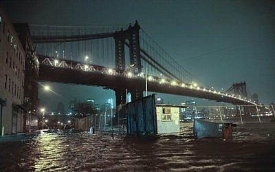 Streets are flooded under the Manhattan Bridge in the Dumbo section of Brooklyn, N.Y., Monday, Oct. 29, 2012. (photo credit: Bebeto Matthews/AP)